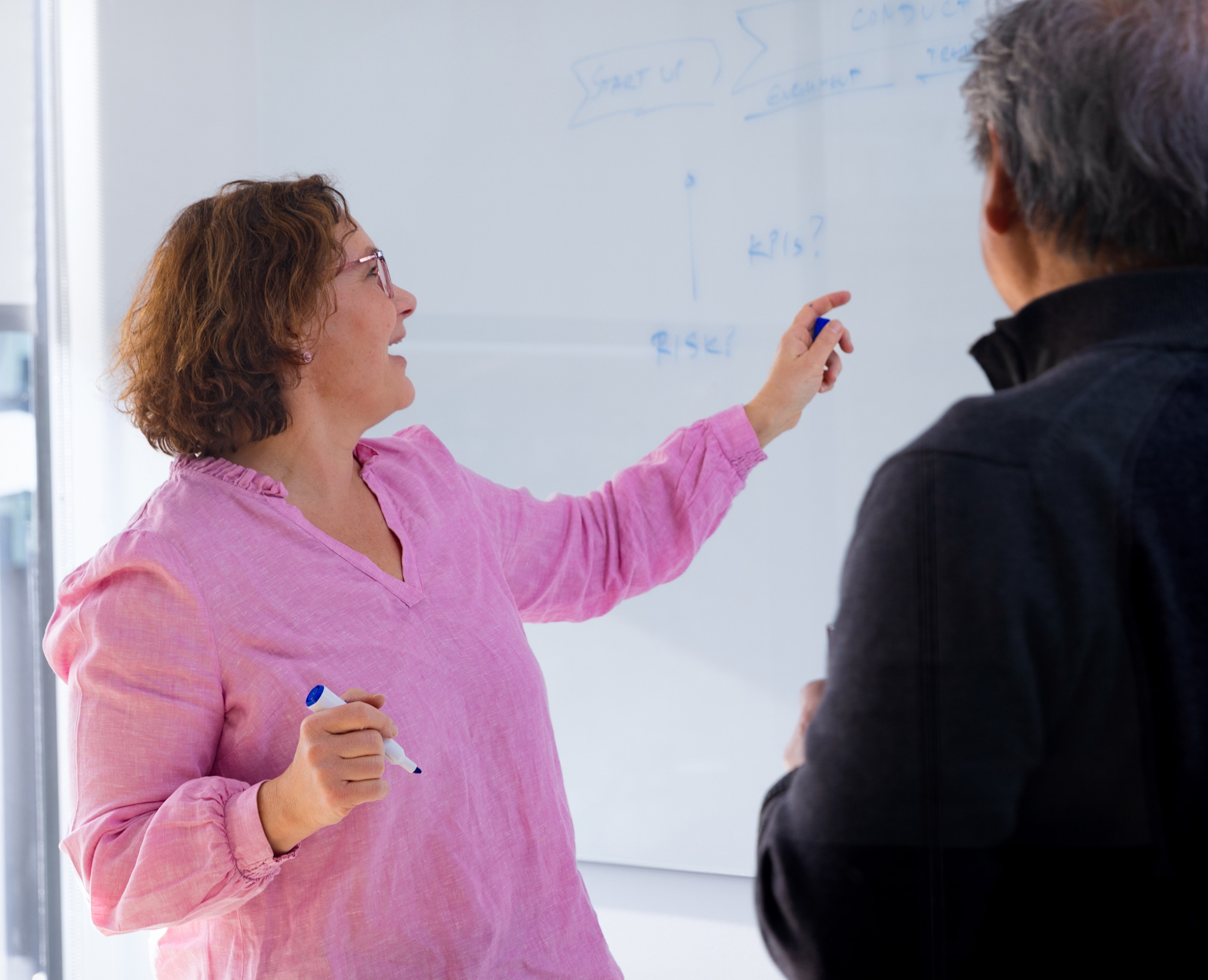 Woman pointing on whiteboard